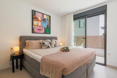 a bedroom with a bed and a large window at Luxe villa Santa Rosalia in Torre-Pacheco