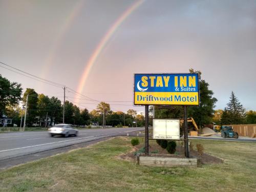 a rainbow over a sign for stay inn and adirty wound motel at Stay Inn and Suites in Niagara Falls