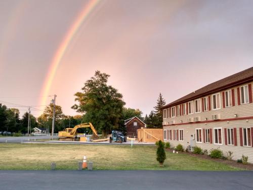a rainbow in the sky over a building at Stay Inn and Suites in Niagara Falls