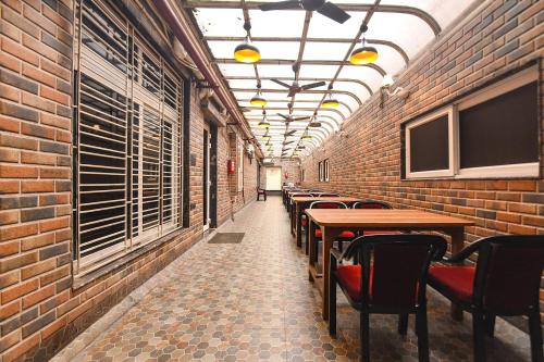 a corridor of a restaurant with tables and chairs at FabHotel Prime Tiyara Inn in Kolkata