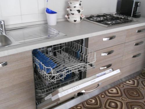 a dishwasher in a kitchen next to a stove at Pepita Flats in San Salvo