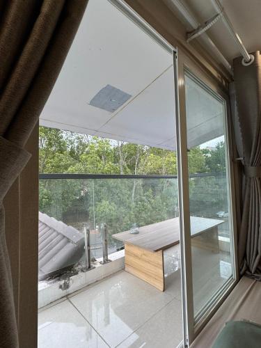 a room with a large glass window and a table at Dahill 196 Dalat in Da Lat