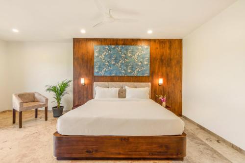 a bedroom with a bed and a chair at Seasons - A Boutique Hotel-Nearby Biological Park in Udaipur