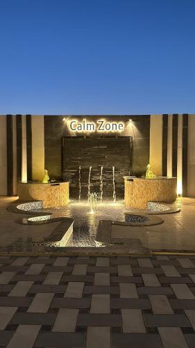 a fountain in front of a building with a blue light at Calm Zone Luxury Private Pool 5BHK Villa in Al Ḩalāh