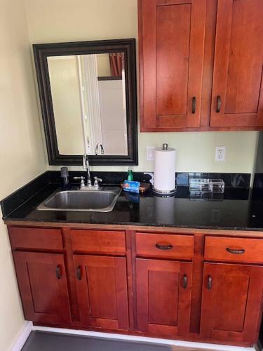 a kitchen counter with a sink and a mirror at Kona Nook - Cozy Studio with Island Warmth in Kailua-Kona