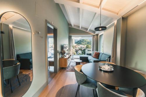 a living room with a table and chairs at HOP Apartments & Suites in Interlaken