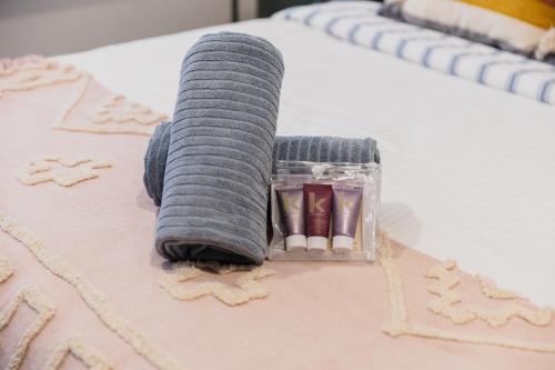 a rolled up towel sitting on top of a bed at Bridge Beach House Central Barwon Heads Sleeps 12 Walk everywhere Accessible lower level bedroom and bathroom in Barwon Heads