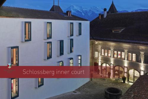 
a building with a sign on the side of it at Boutique Hotel Schlossberg in Thun
