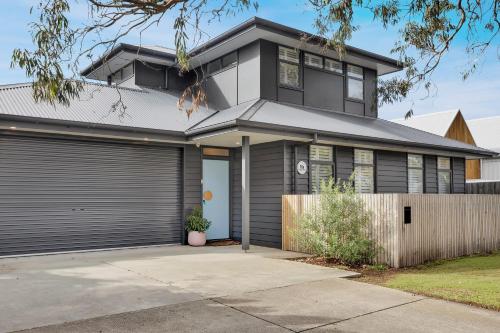 a house with a garage at Bridge Beach House Central Barwon Heads Sleeps 12 Walk everywhere Accessible lower level bedroom and bathroom in Barwon Heads