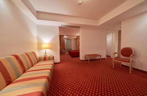 a living room with a couch and a chair at Hotel Bristol in Bellaria-Igea Marina