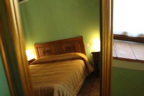 a bedroom with a bed in a green room at Agriturismo Vezzano in Chiusi della Verna