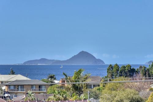a view of the ocean with mountains in the background at Oasis at Salamander Bay in Salamander Bay