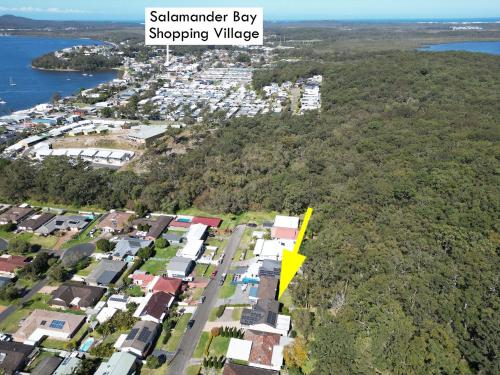an aerial view of a suburb with a yellow arrow at Oasis at Salamander Bay in Salamander Bay