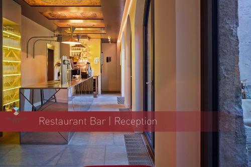 a hallway with a restaurant bar in a room at Boutique Hotel Schlossberg in Thun
