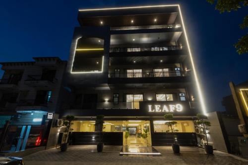 a lit up building with a lease sign on it at Leaf 9 Grand, Near Udyog vihar and Yashobhoomi in Gurgaon