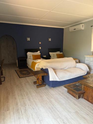 a bedroom with two beds and a table in it at 7 on West in Postmasburg
