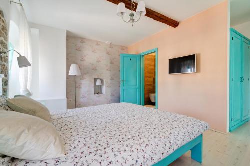 a bedroom with a bed and blue doors at Heritage Hotel Chersin in Fažana