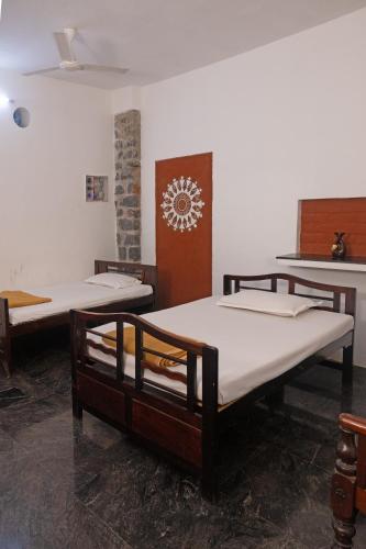 a room with two beds in a room at Pathayam Inn in Tiruvannāmalai