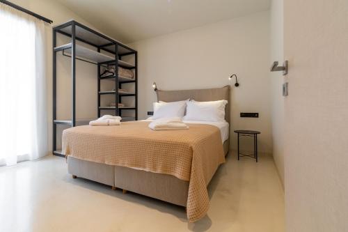 a bedroom with a large bed in a room at Alkida Luxury Rooms Tolo in Tolo