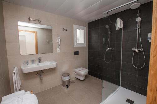 a bathroom with a sink toilet and a shower at Hotel Villa Flamenca in Nerja