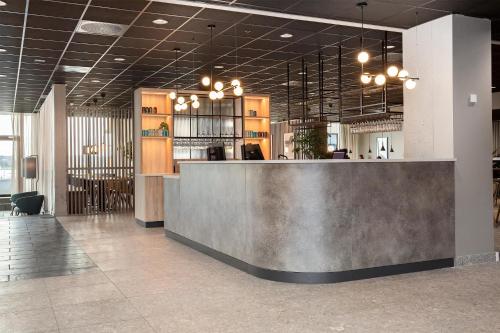 a lobby with a reception desk in a building at Radisson Hotel Haugesund in Haugesund