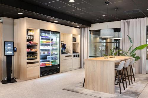 a kitchen with a table and a drink refrigerator at Radisson Hotel Haugesund in Haugesund