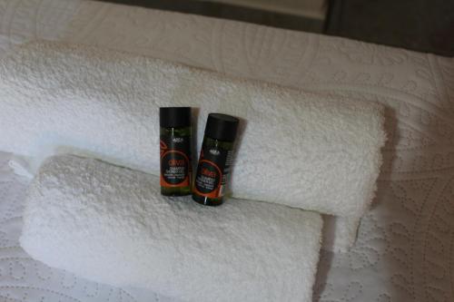 two bottles of toilet paper on a pile of towels at My Rooms in Chania Town