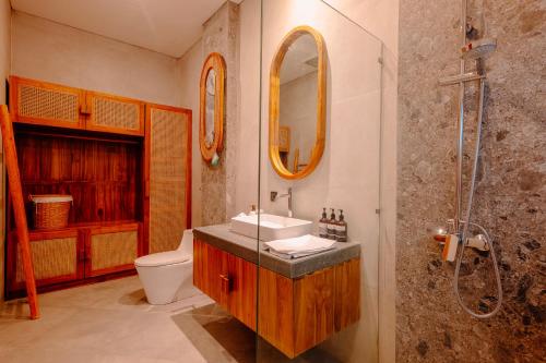 a bathroom with a sink and a toilet and a shower at Charming 2BR Retreat with Private Pool & Garden View in Dalung