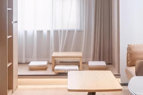 a living room with a couch and a table at Holiday Inn Express Suzhou City Center by IHG in Suzhou