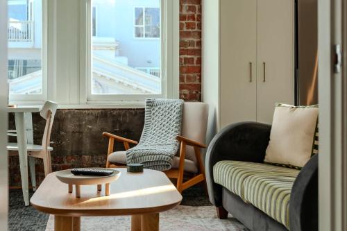 a living room with two chairs and a coffee table at Modern 2-Bedroom Central City Apartment in Wellington