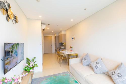 a living room with a couch and a table at The Song Your House Apartment - Căn Hộ Du Lịch Biển Vũng Tàu in Vung Tau