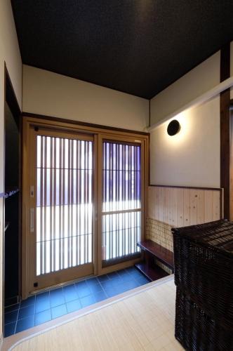 an empty room with sliding glass doors in a building at Suzuan 鈴庵 in Takamatsu