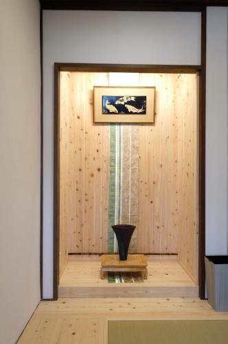 a room with a wooden door with a vase in it at Suzuan 鈴庵 in Takamatsu
