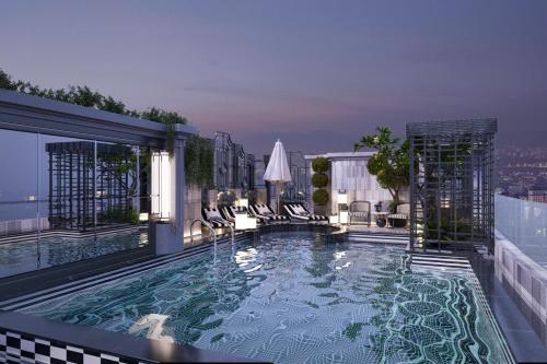 a swimming pool on top of a building at Manevi Premier Hotel in Hanoi