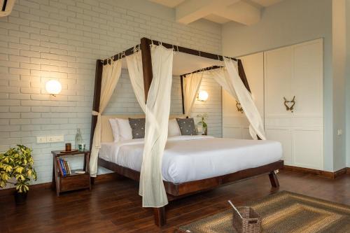a bedroom with a bed with a canopy at La Viola, 3BHK Villa with rooftop Jacuzzi, close to Anjuna & Vagator Beach with Private Pool, Kitchen, Terrace in Anjuna