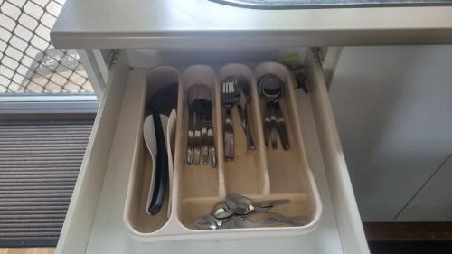 a drawer filled with utensils in a refrigerator at KS Maryborough 2-Bedroom Apartment in Maryborough