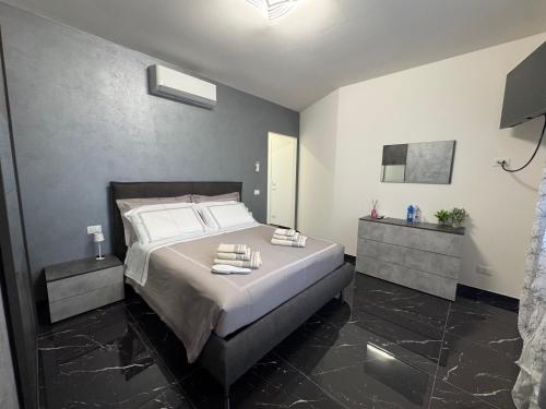 a bedroom with a large bed with two night stands at Aurora Rooms and Suite in Albignasego