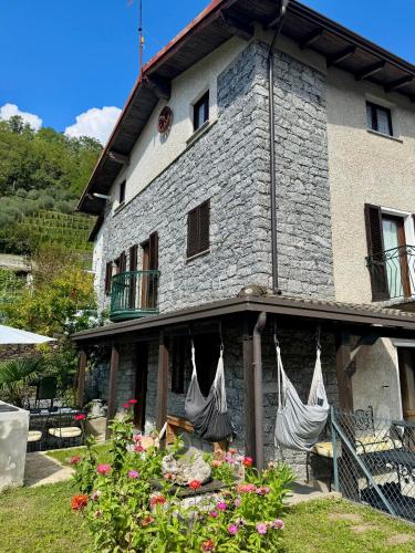 a building with hammocks on the side of it at casa vacanza l'Oleandro in Poggiridenti