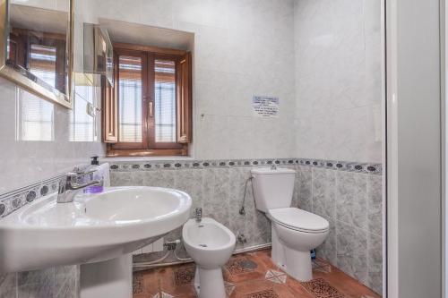 a bathroom with a sink and a toilet at Casa Roque in Monachil