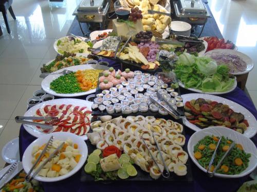 a buffet with many plates of food on a table at Awa Resort Hotel in Encarnación