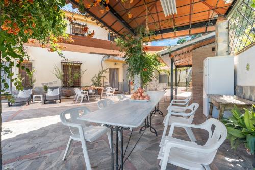 a white table and chairs on a patio at Casa Roque in Monachil