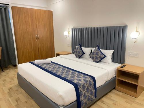 a bedroom with a large bed in a room at Novara Hotel Madhapur in Hyderabad