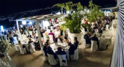 a group of people sitting at tables at a wedding at Hotel Belvedere Resort in Castellammare del Golfo