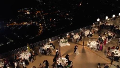 a bride and groom dancing on a balcony at a wedding at Hotel Belvedere Resort in Castellammare del Golfo