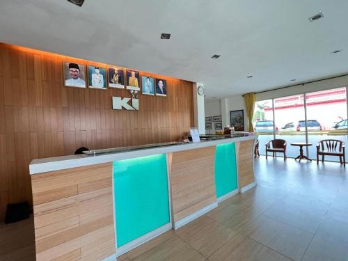 a lobby with a bar with blue and green at King Ing Hotel in Mukah