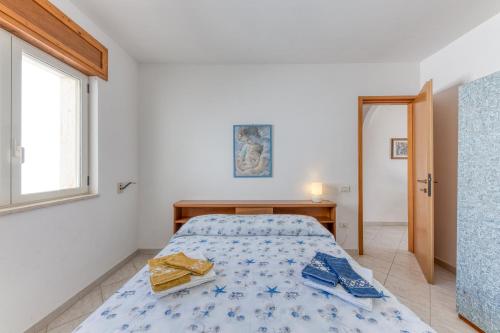 a bedroom with a bed and a window at Ruggeri 1 Leuca apartments in Marina di Leuca