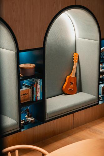 a guitar sitting on a shelf in a room at Rosewood Doha in Doha