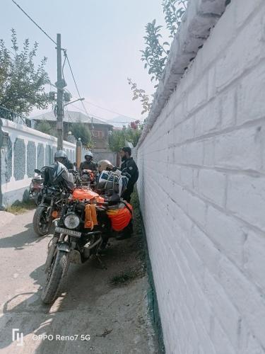 two motorcycles are parked next to a wall at Moonshine Homestay Kashmir in Srinagar