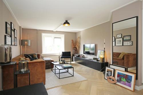 a living room with a couch and a mirror at Bright City Retreat near Center & RAI in Amsterdam