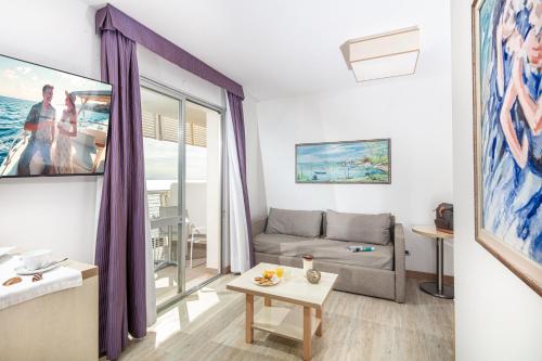 a living room with a couch and a table at Hotel San Giorgio Resort 4S in Caorle